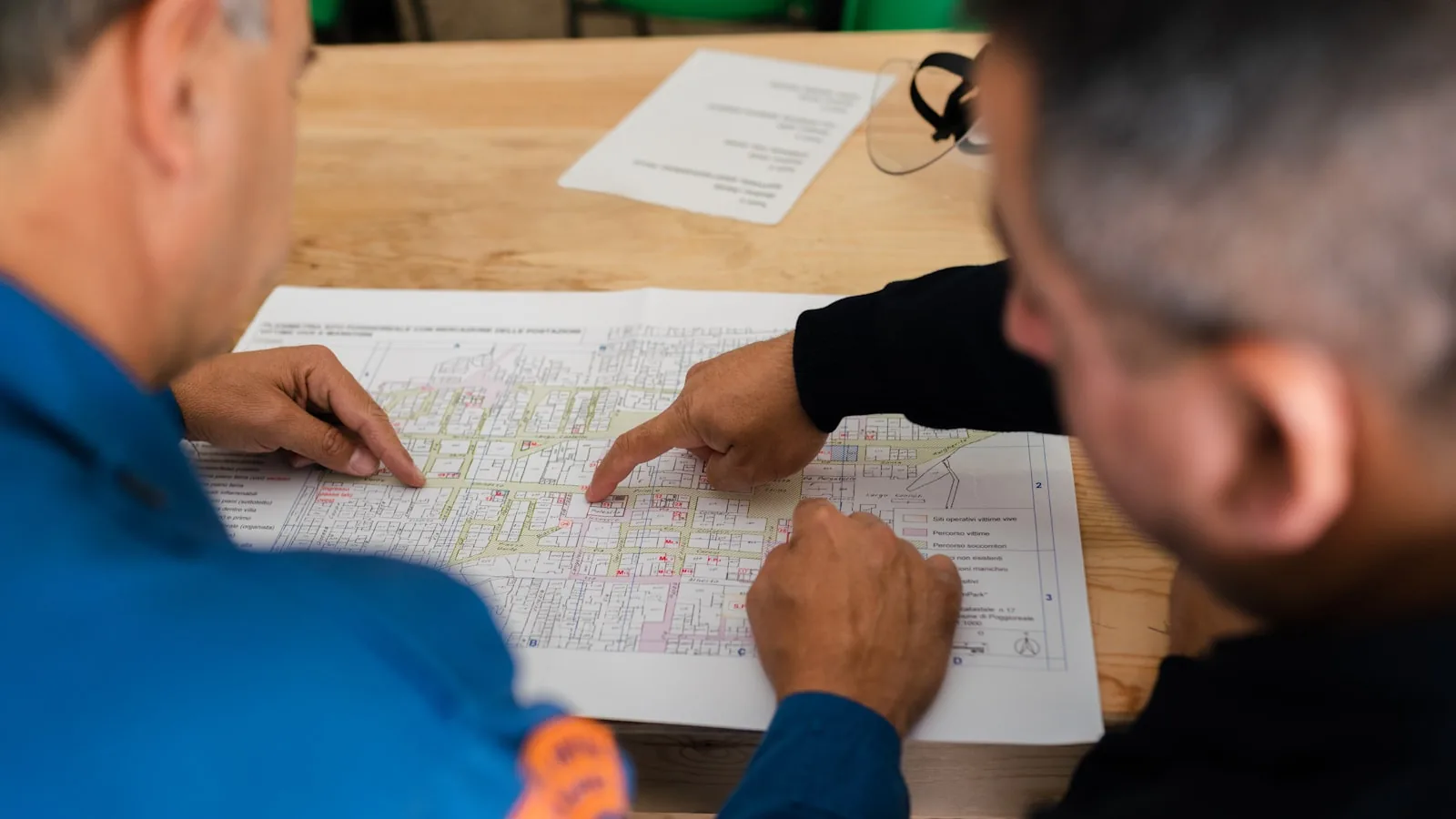 Two operations staff planning work across a territory map